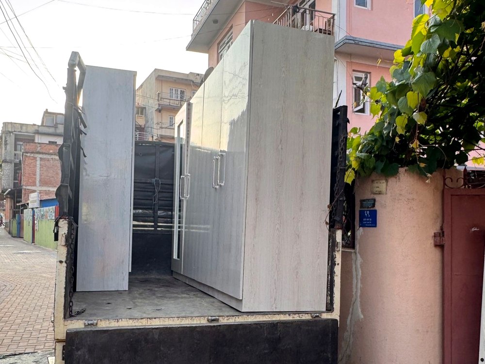 Wardrobes loaded on truck during house shifting